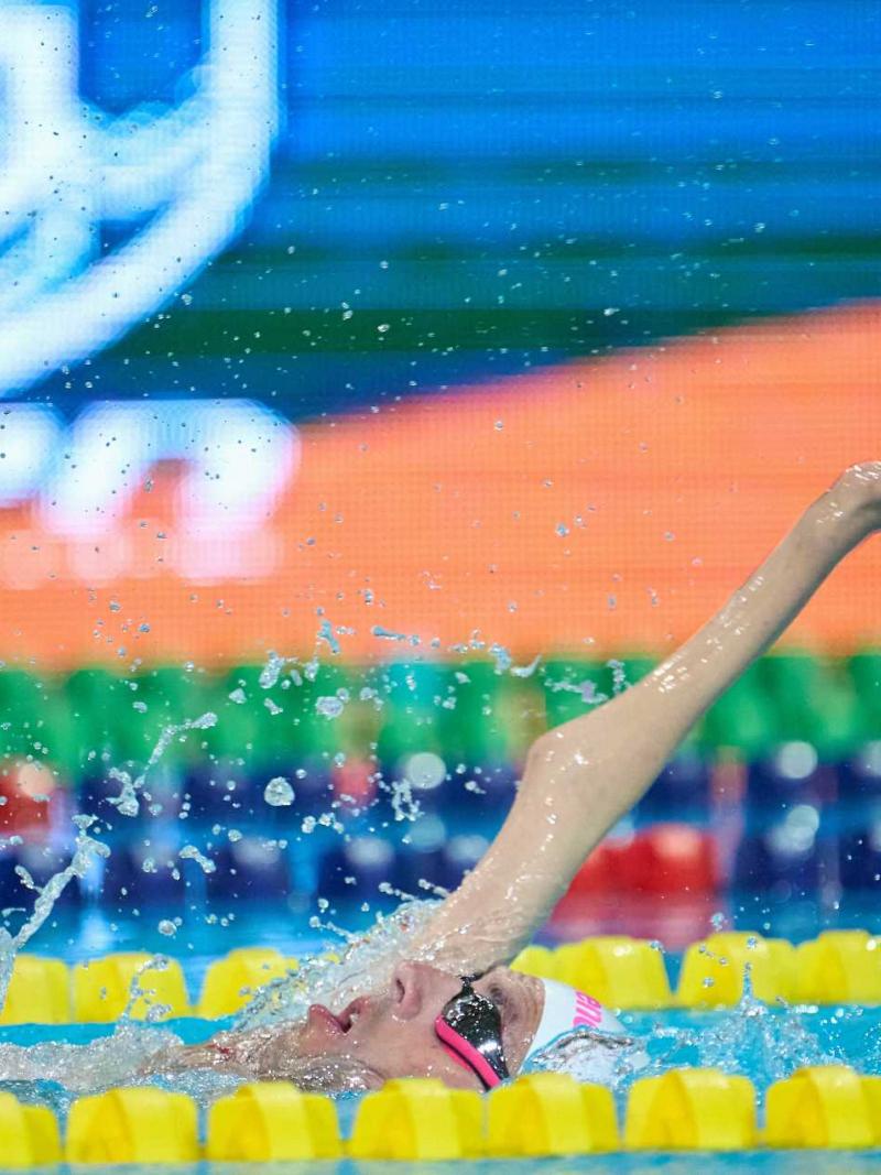 A male swimmer with a disability in his right arm in a swimming pool 
